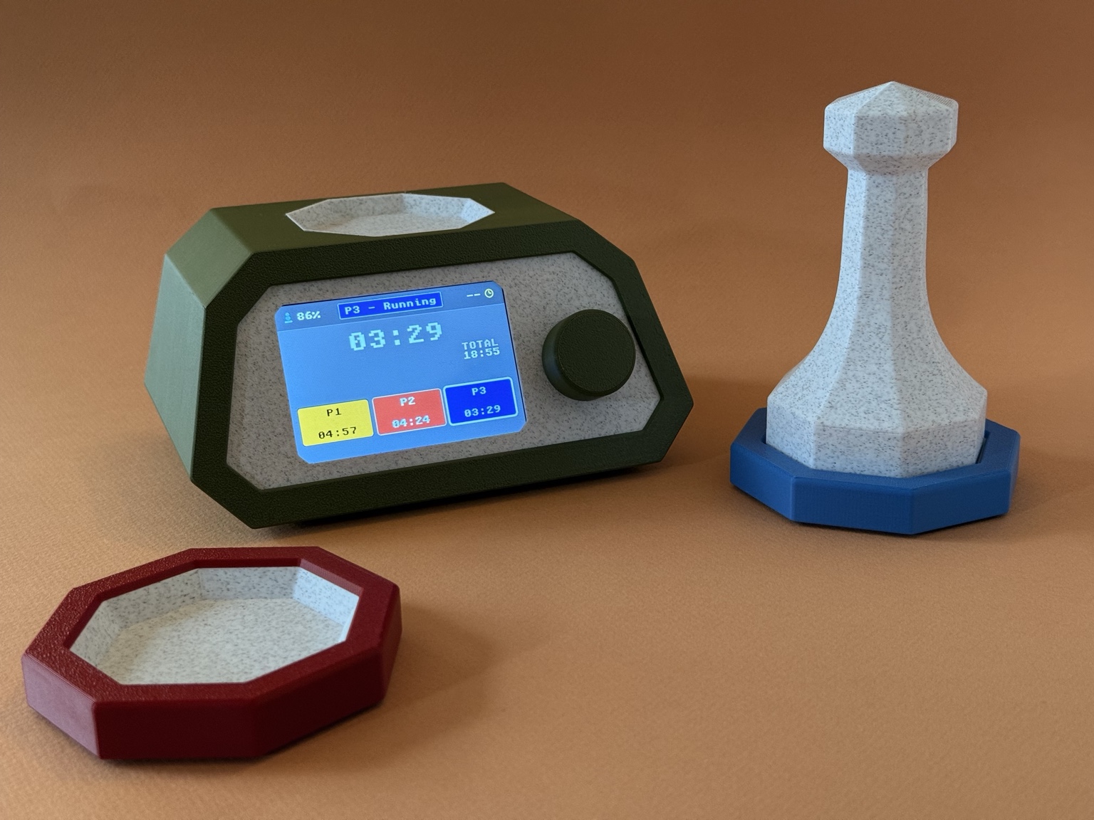 DigiPawn tabletop timer console with a white pawn and colorful player coasters on a warm terracotta background